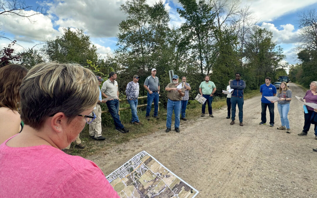 WWA's Executive Director Tracy Hames stands in the middle of a circle of people, which include Natural Resource Board members and LPRWEP partners.